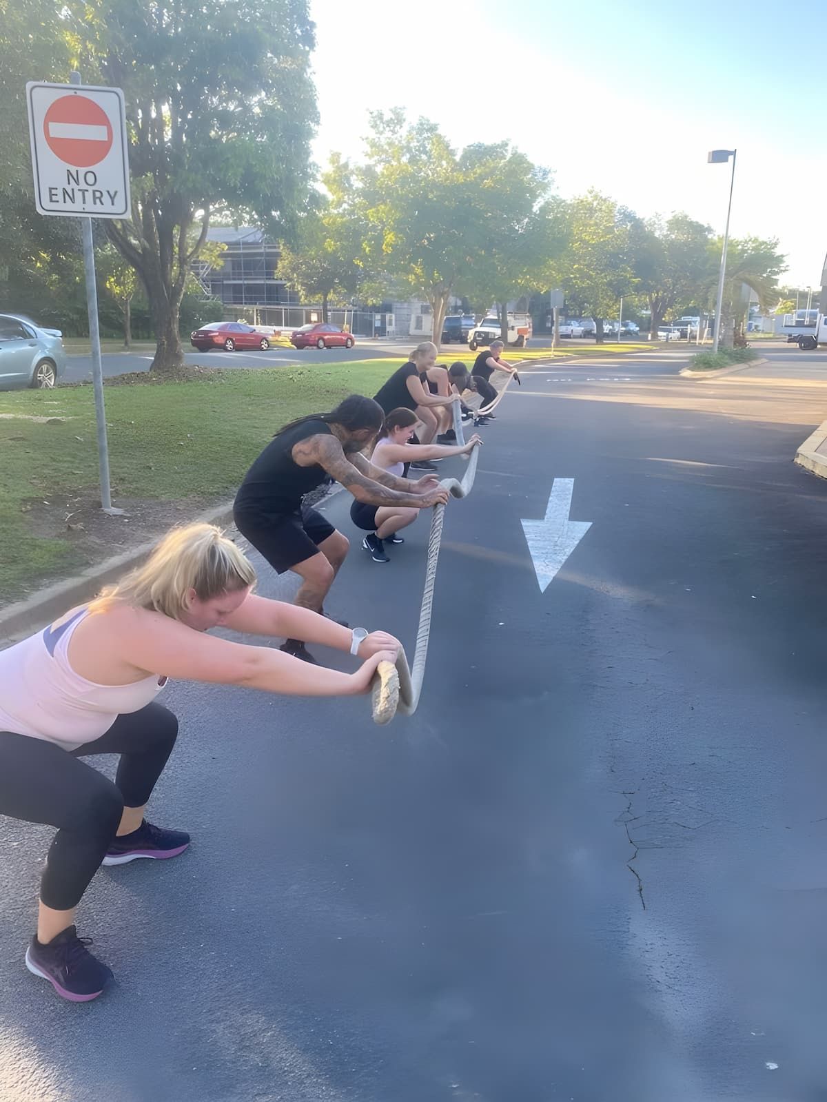A Group of People Are Doing Squats on The Side of The Road — Maxenergy Fitness In Smithfield, QLD