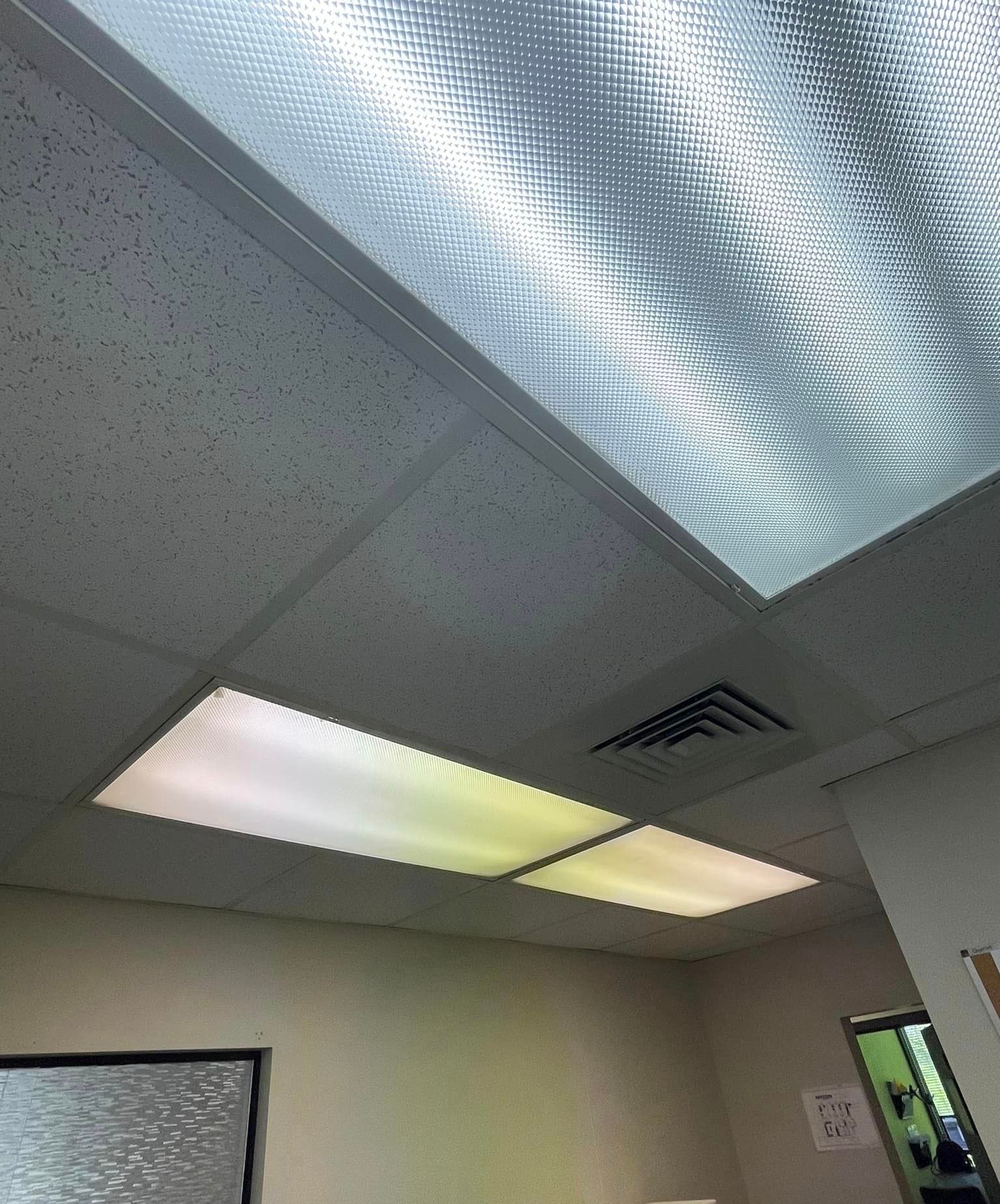 A room with a ceiling that has a lot of lights on it