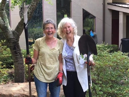 Two parishioners smiling in Memorial Garden