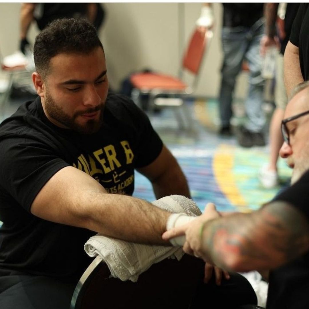 Students performing martial arts drills under professional instruction at Killer B Combat Academy.