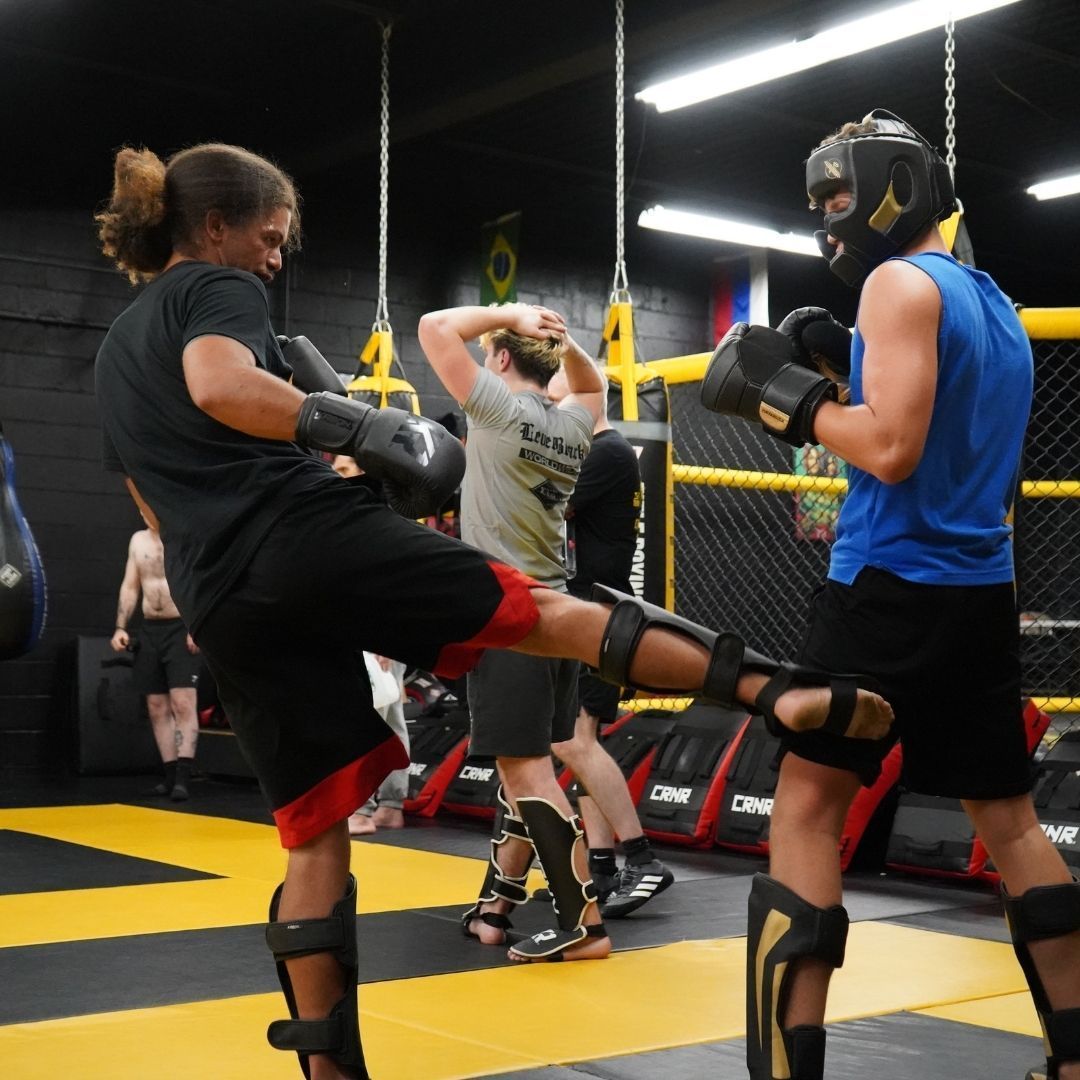 Martial arts instructor coaching students during training at Killer B Combat Academy.