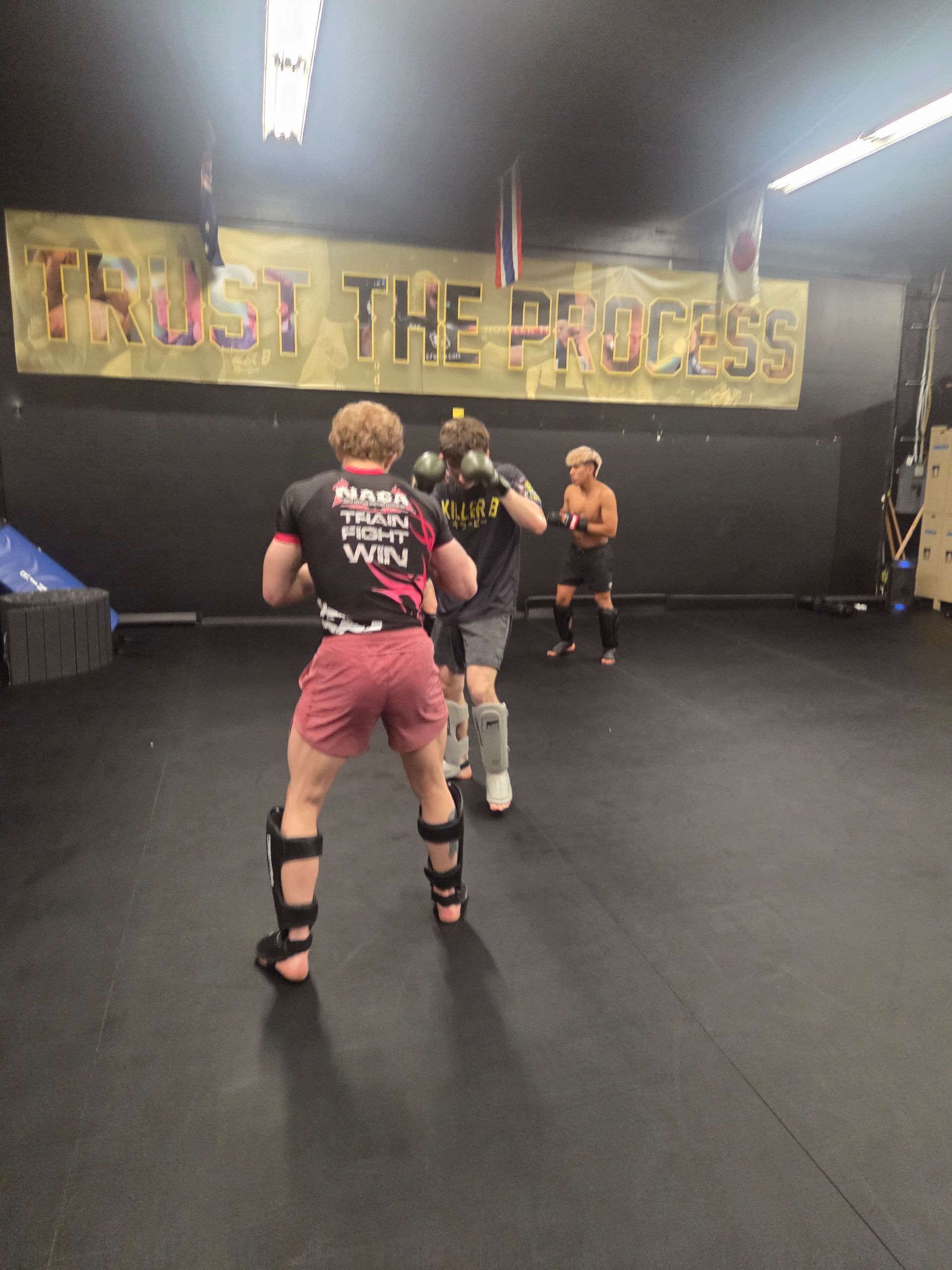 Students participating in a dynamic martial arts workout at Killer B Combat Academy.