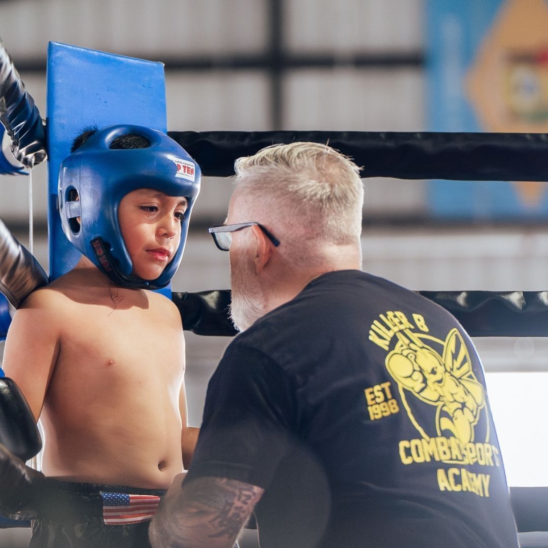 Killer B Combat Academy instructor guiding students through martial arts training drills.