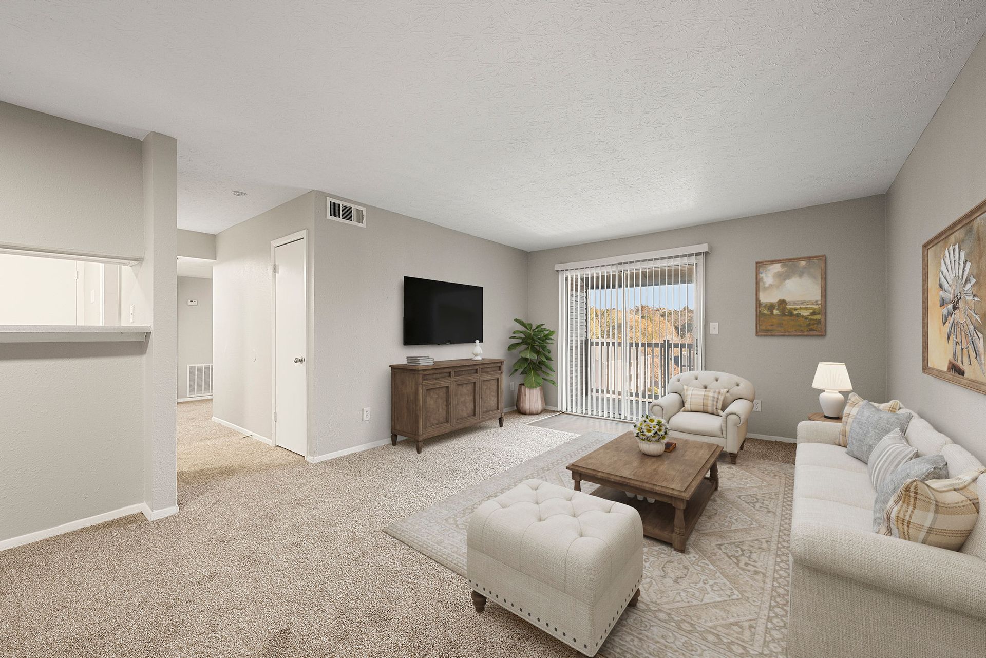 Bright beige living room with sectional sofa, ottoman, TV, wooden coffee table, and window light