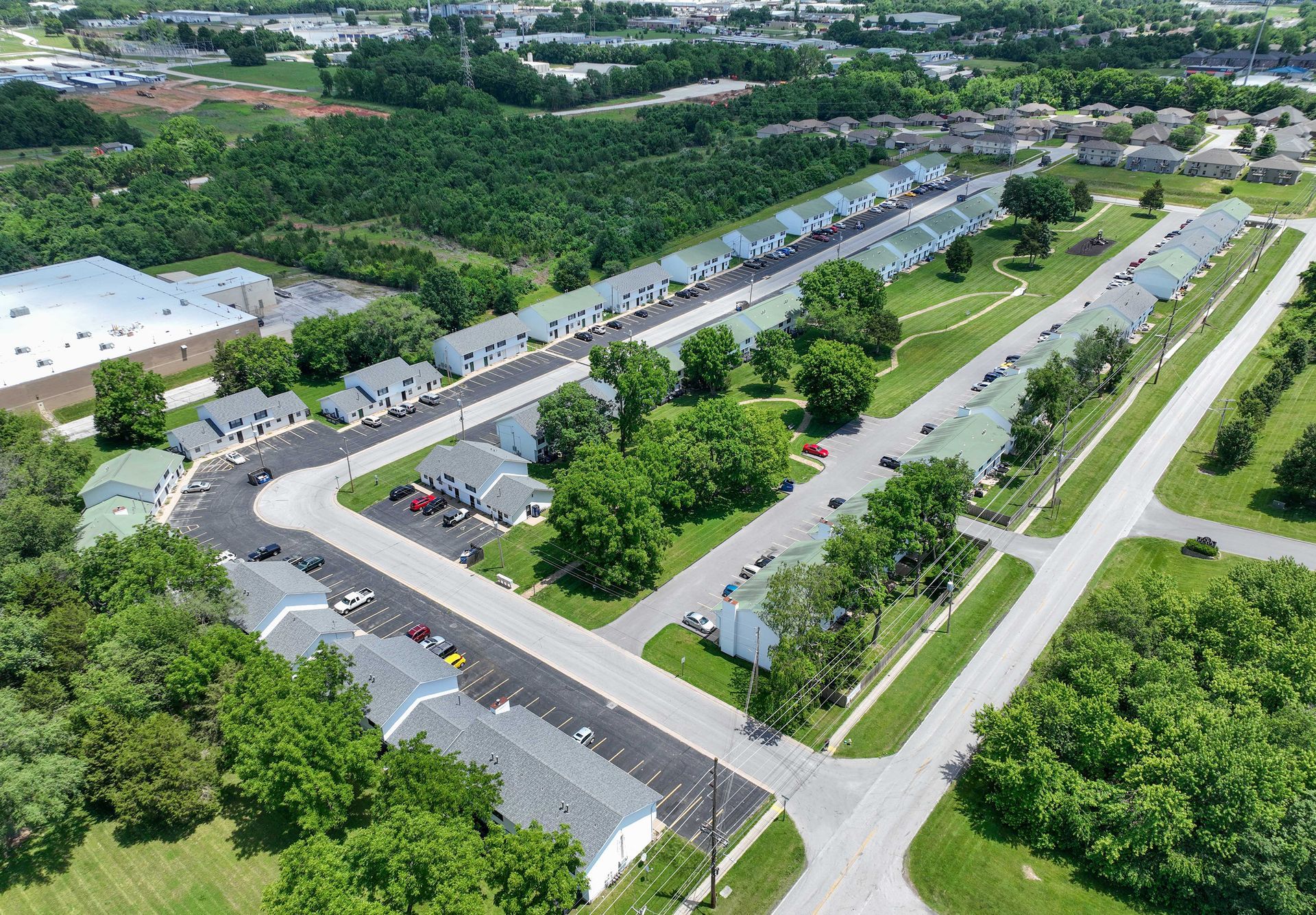 An aerial view of a residential area with lots of trees and houses.