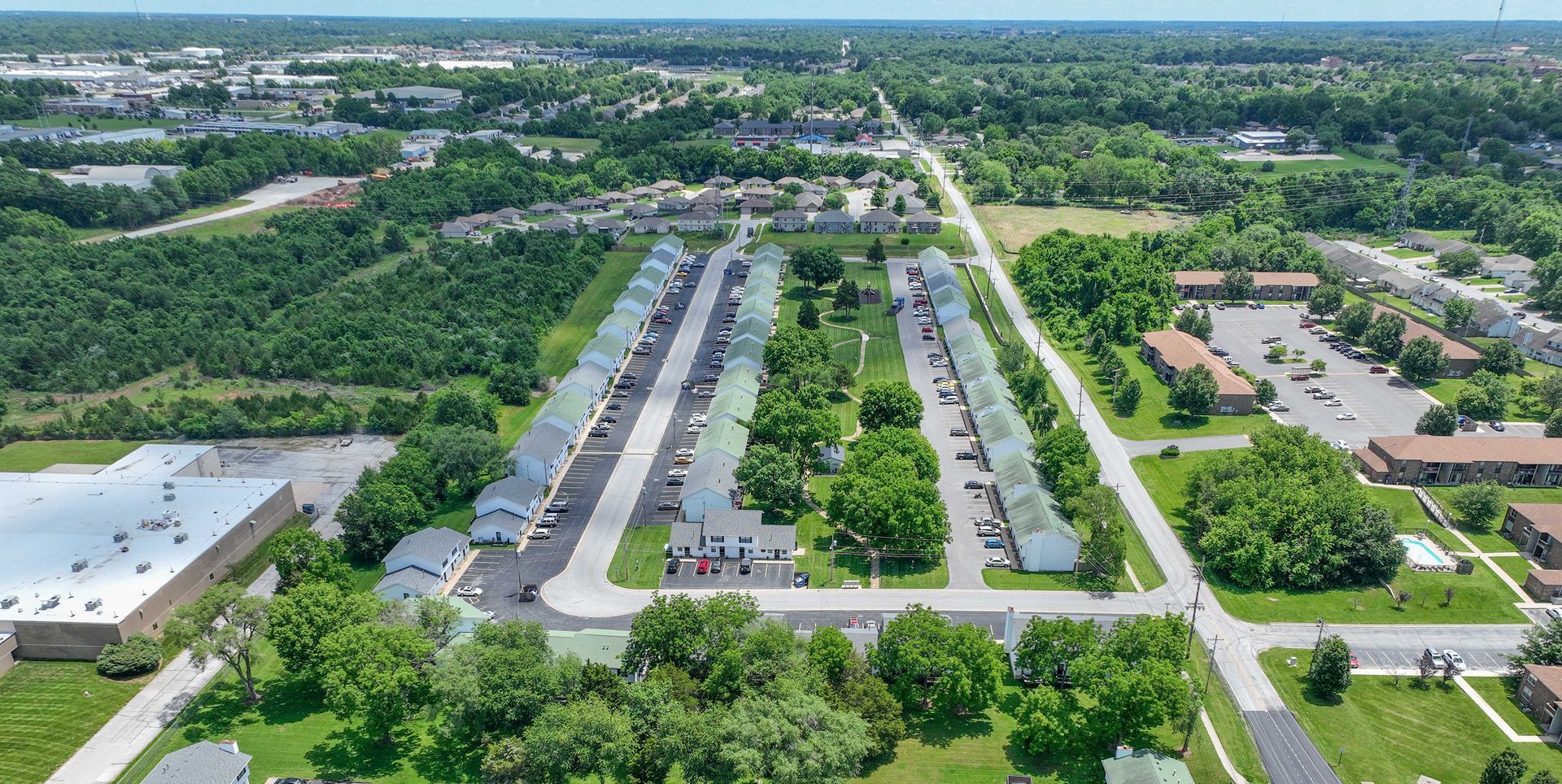 An aerial view of a residential area with lots of trees and buildings.
