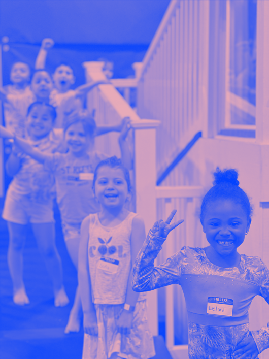 A group of young girls are posing for a picture in a gym.