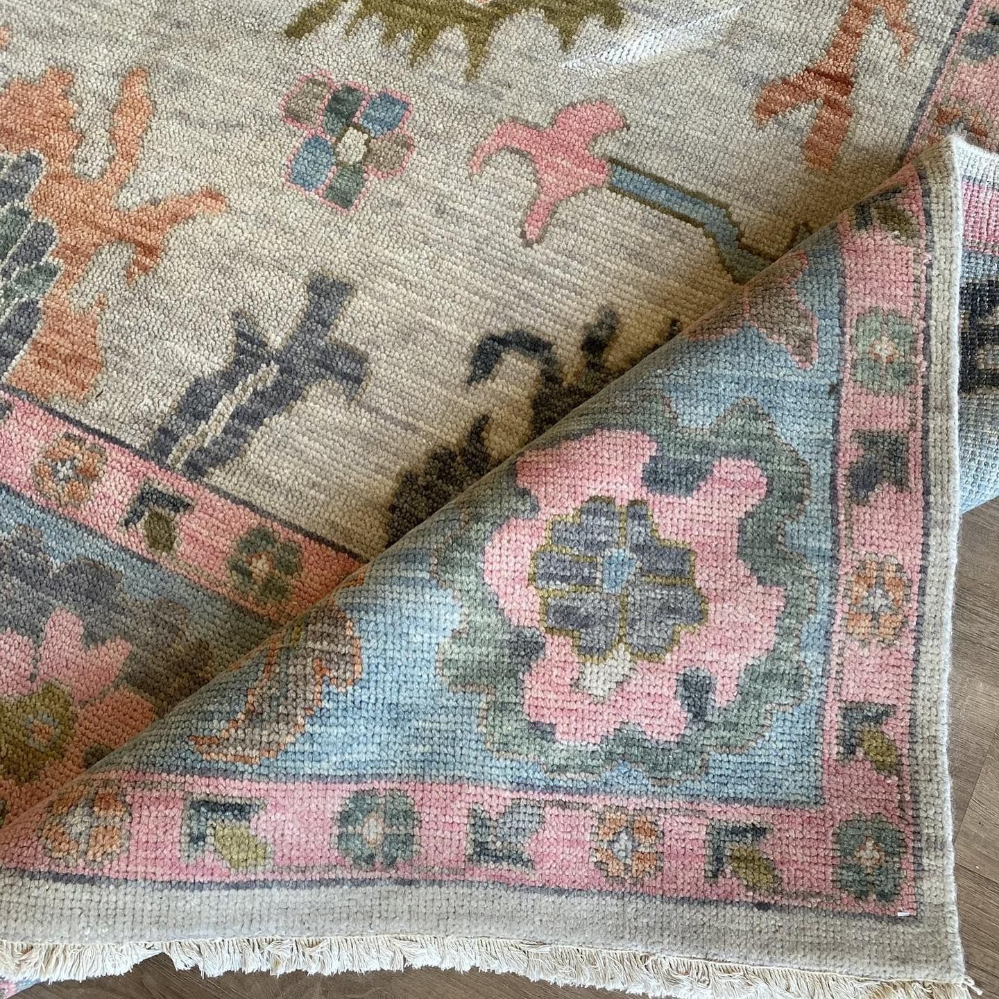 A close up of a rug with a floral pattern on it.