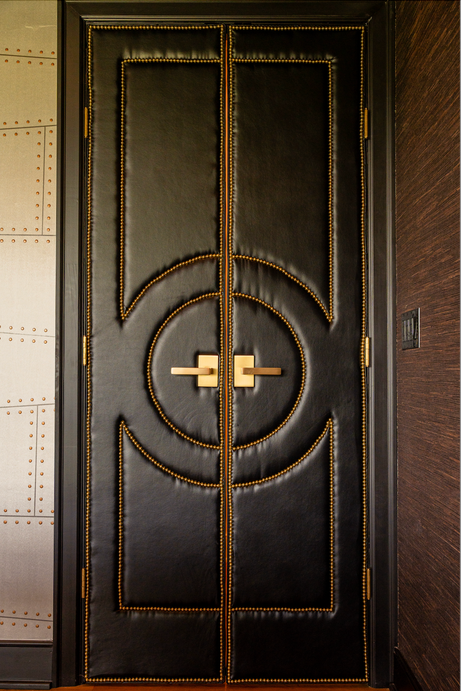 A black and gold door with a circular design on it