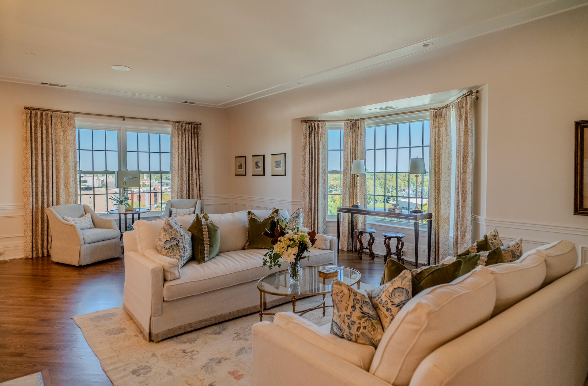 A living room filled with furniture and a large window.