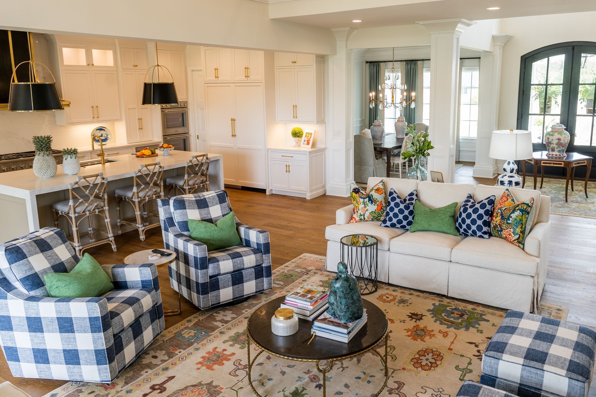 A living room with a couch , chairs , and a coffee table.