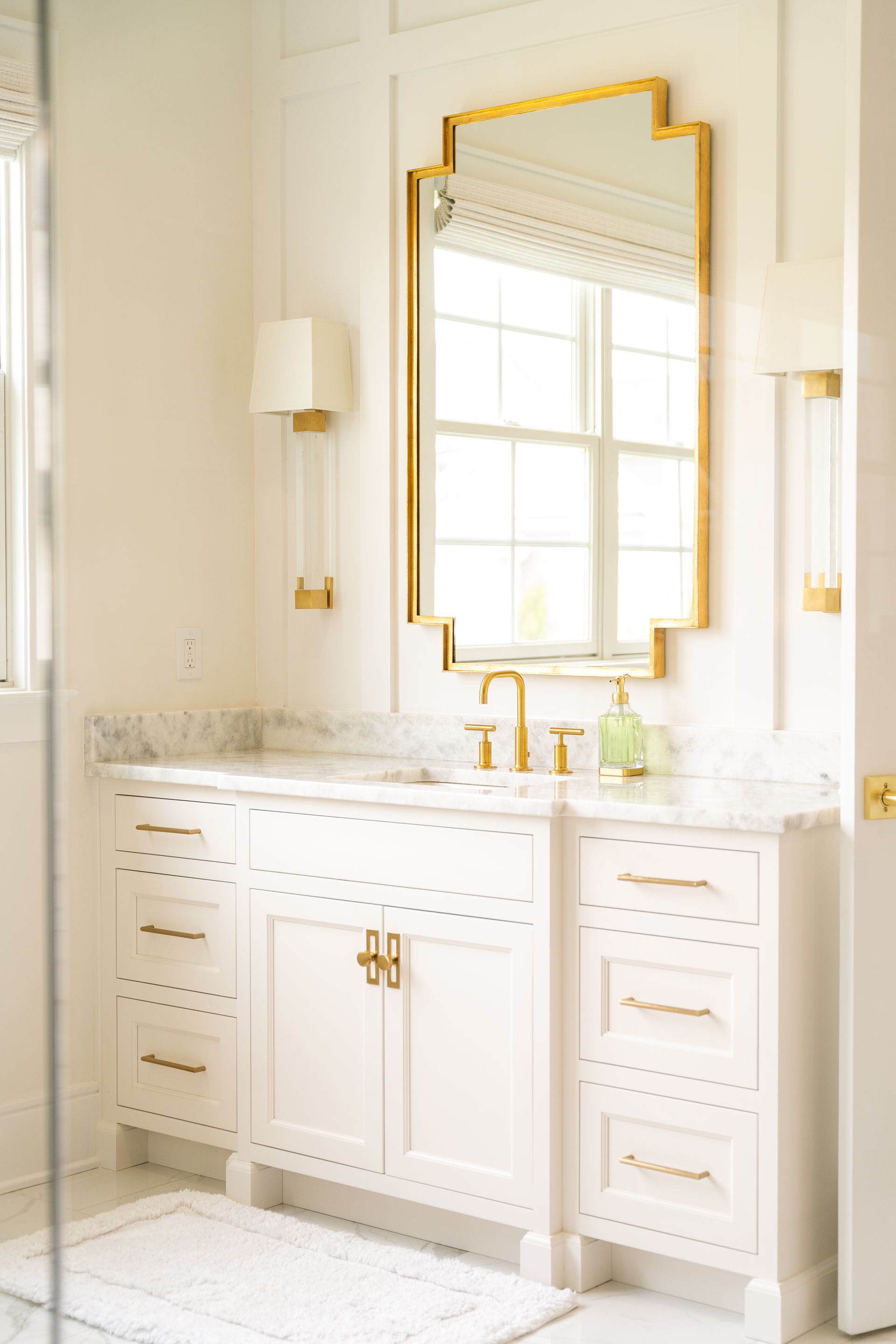 A bathroom with two sinks , a mirror , and a shower.