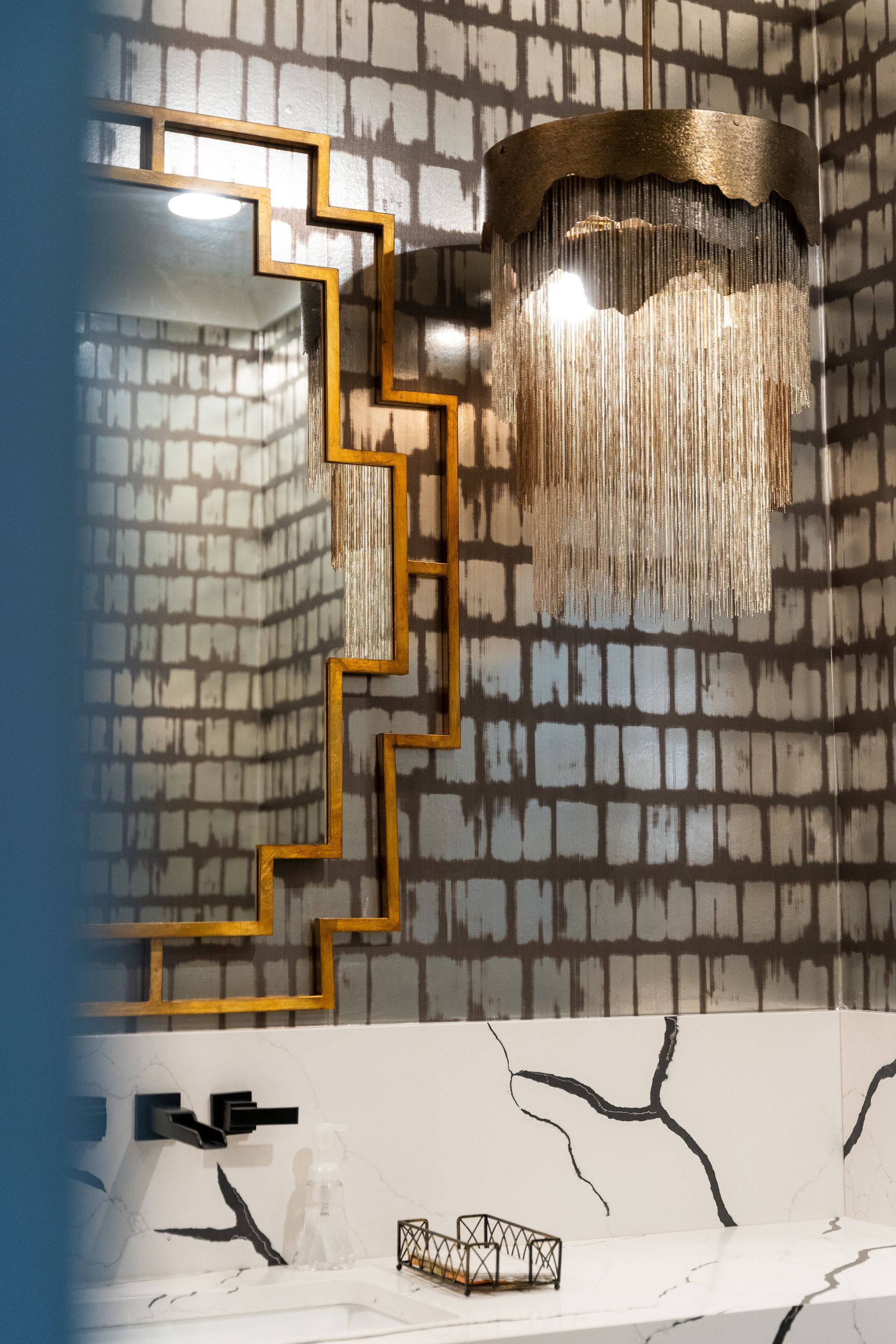 A bathroom with a chandelier hanging from the ceiling