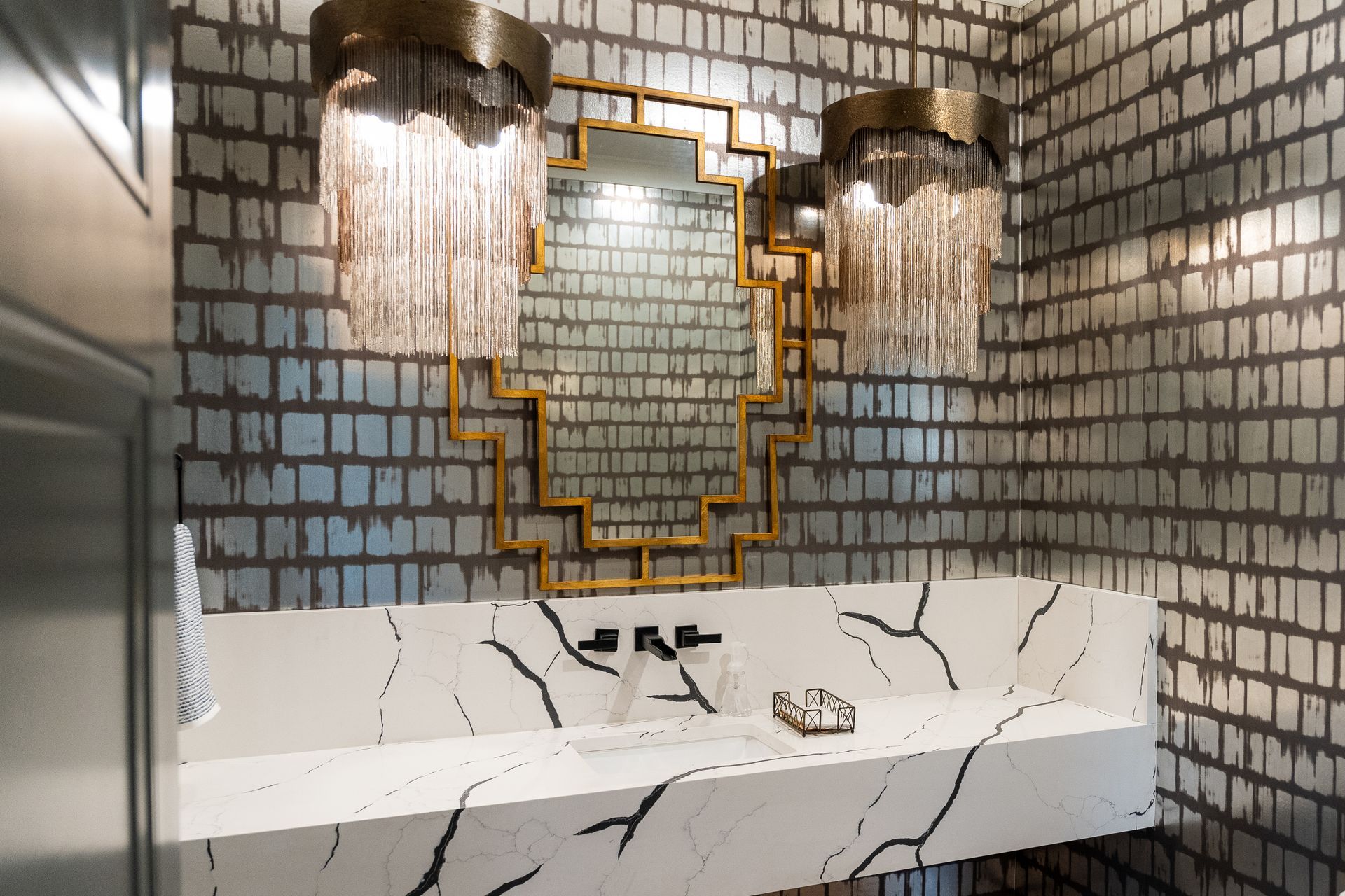 A bathroom with a sink and a mirror on the wall.