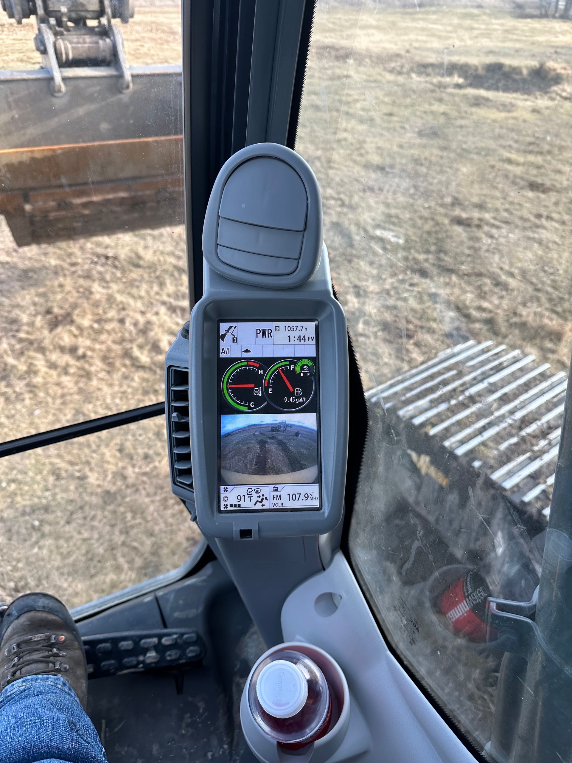 Cab cab display showing a camera feed and map, with a control knob in the foreground.