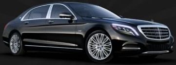 A black mercedes benz s class is parked on a black background.
