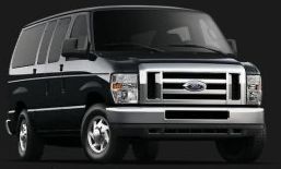 A black ford van is parked on a black background