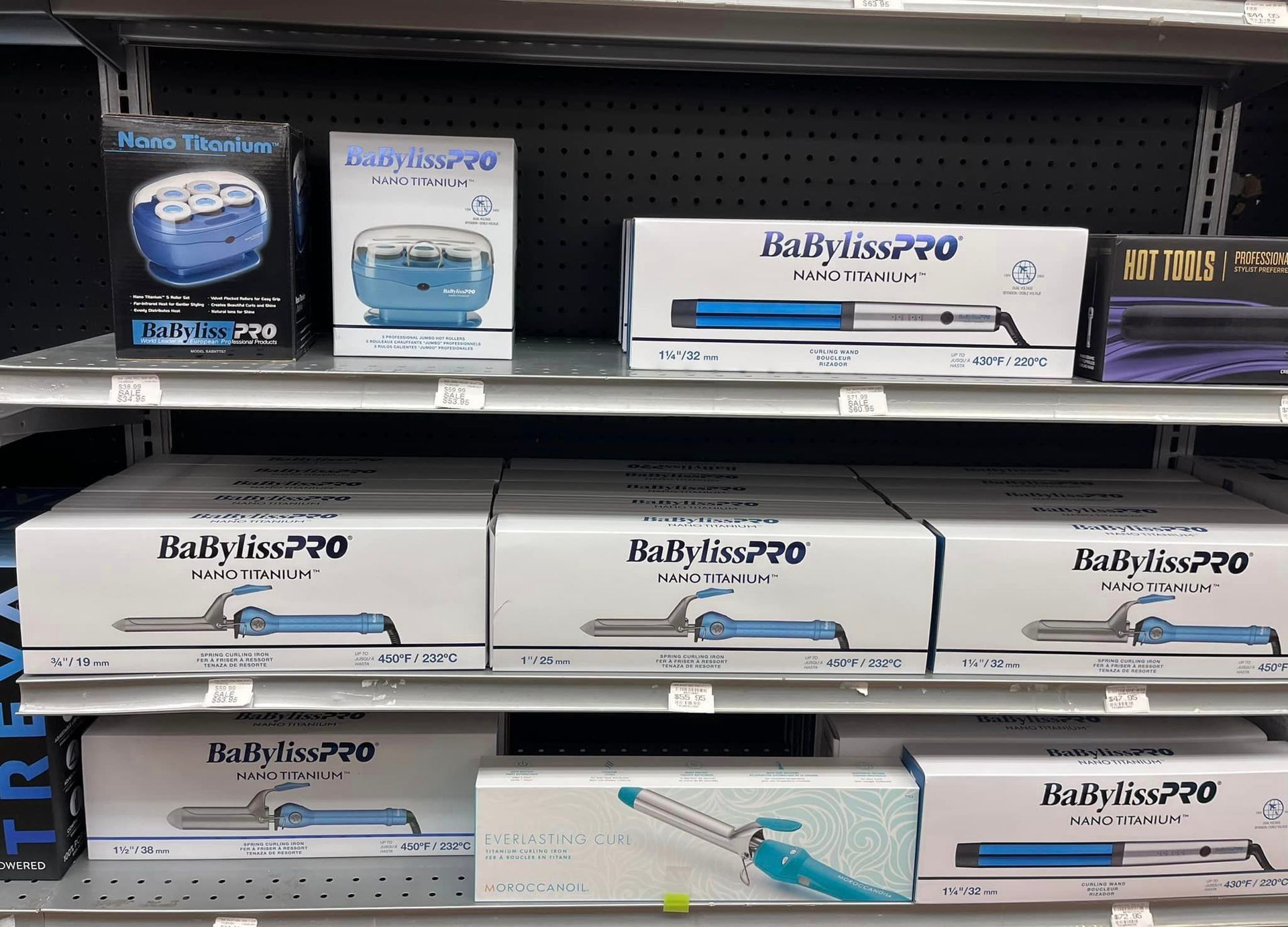 a store shelf filled with boxes of babyliss hair straighteners