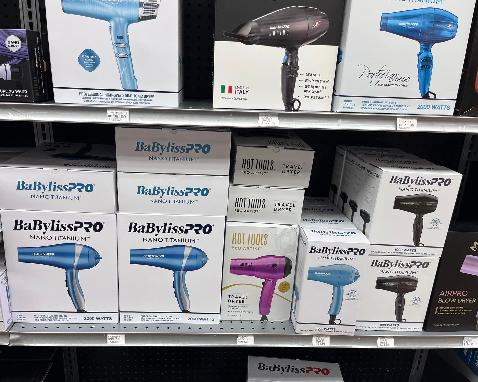 a shelf filled with boxes of babyliss hair dryers