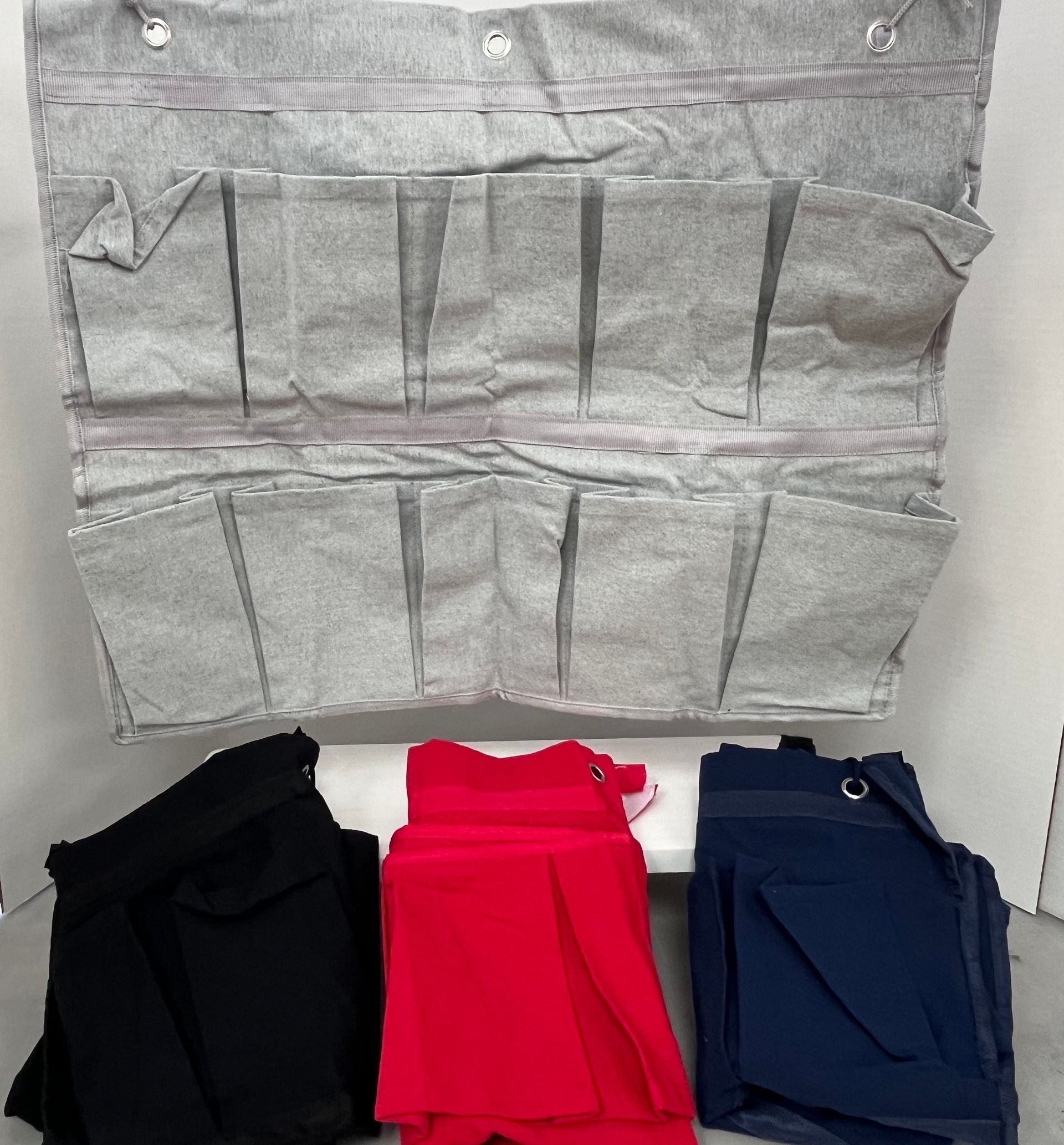 three pairs of pants are sitting next to each other on a table .