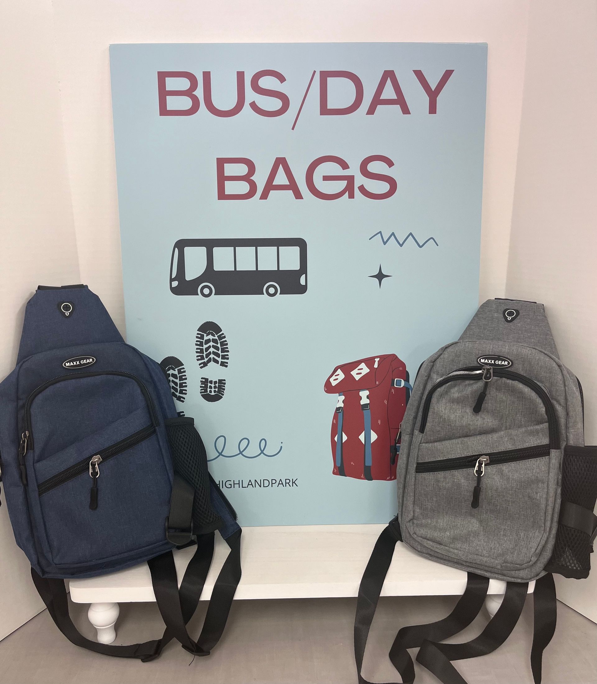 two bags are sitting in front of a sign that says bus / day bags