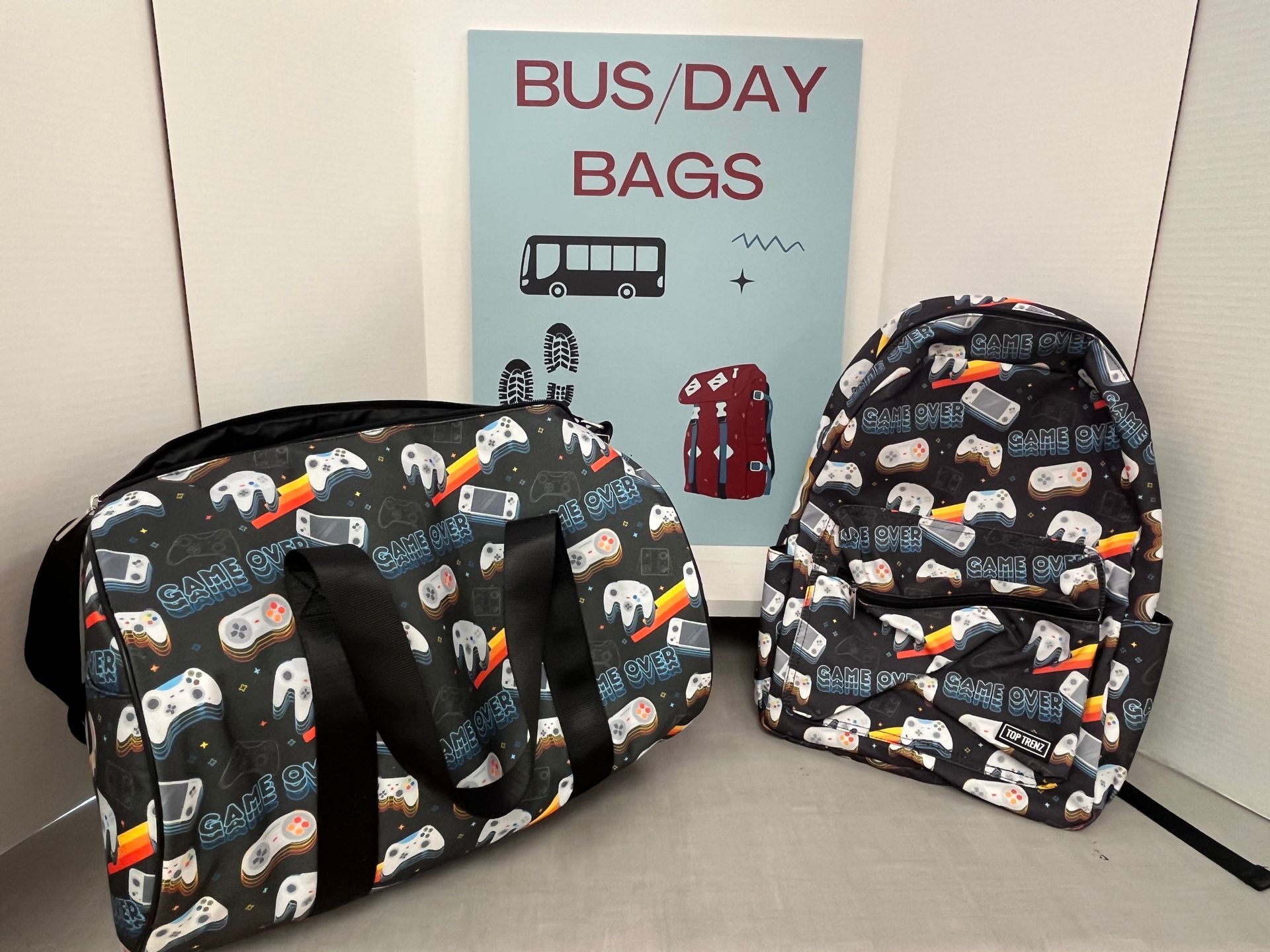 two bags are sitting next to a sign that says bus day bags