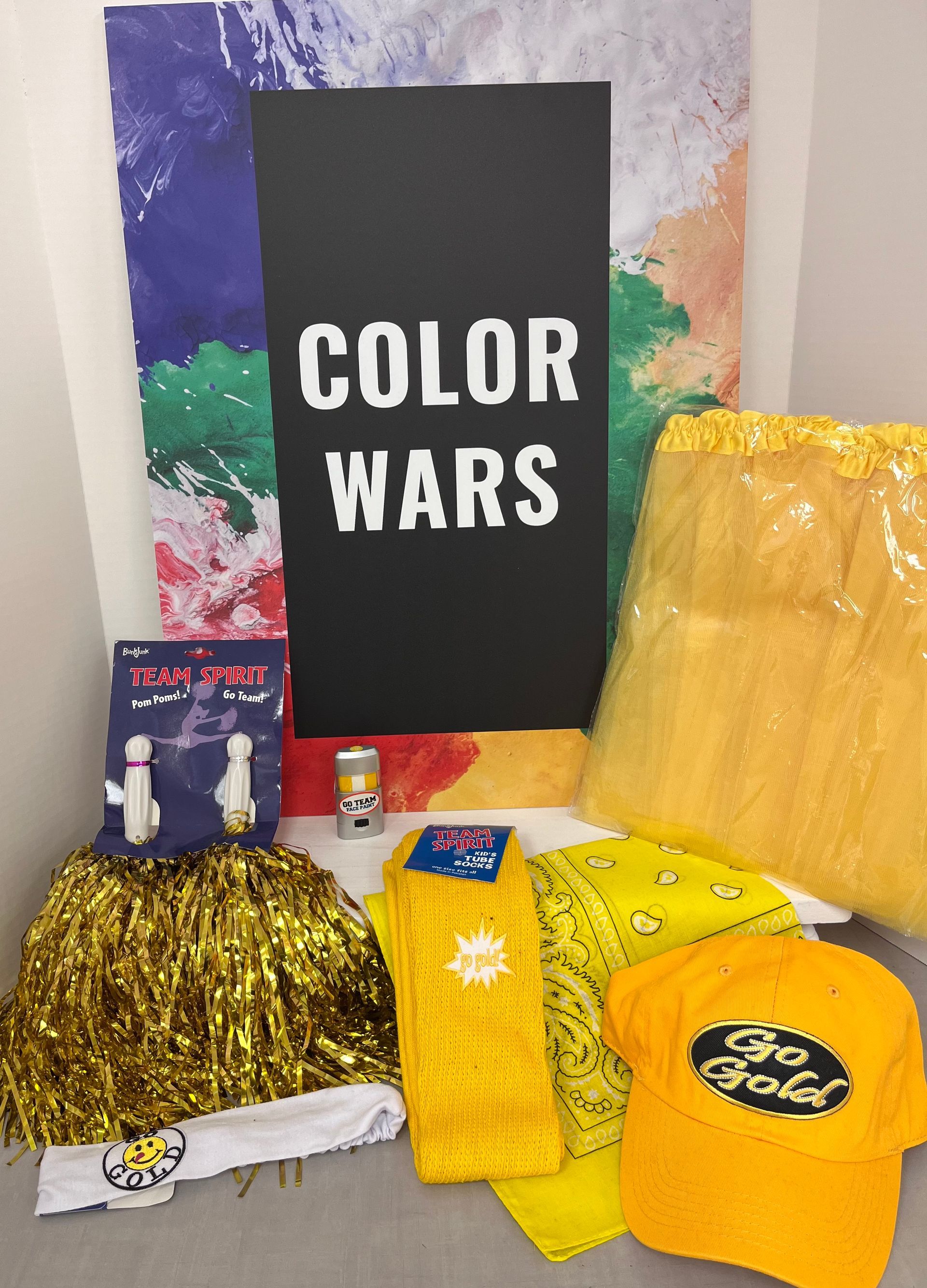 a bunch of yellow items are on a table with a sign that says color wars