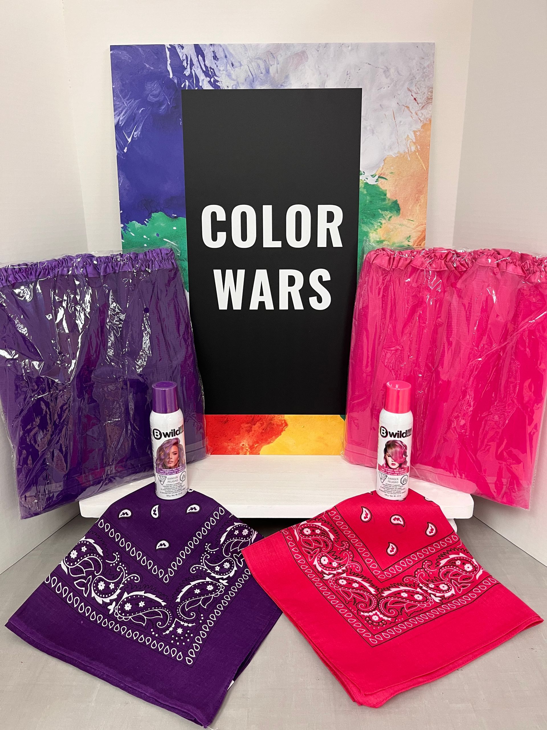 a sign that says color wars is surrounded by bandanas and spray paint