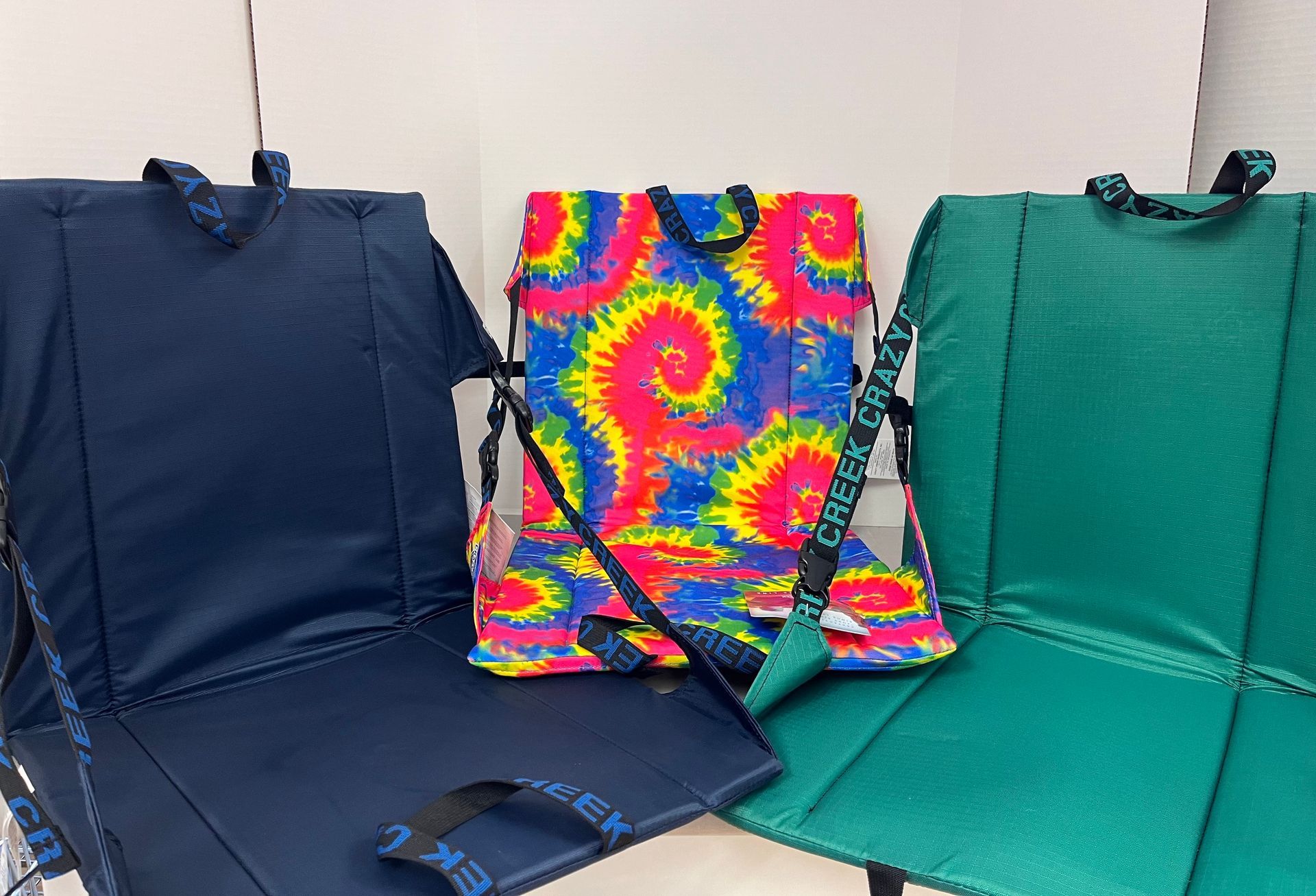 three folding chairs are sitting next to each other on a table .