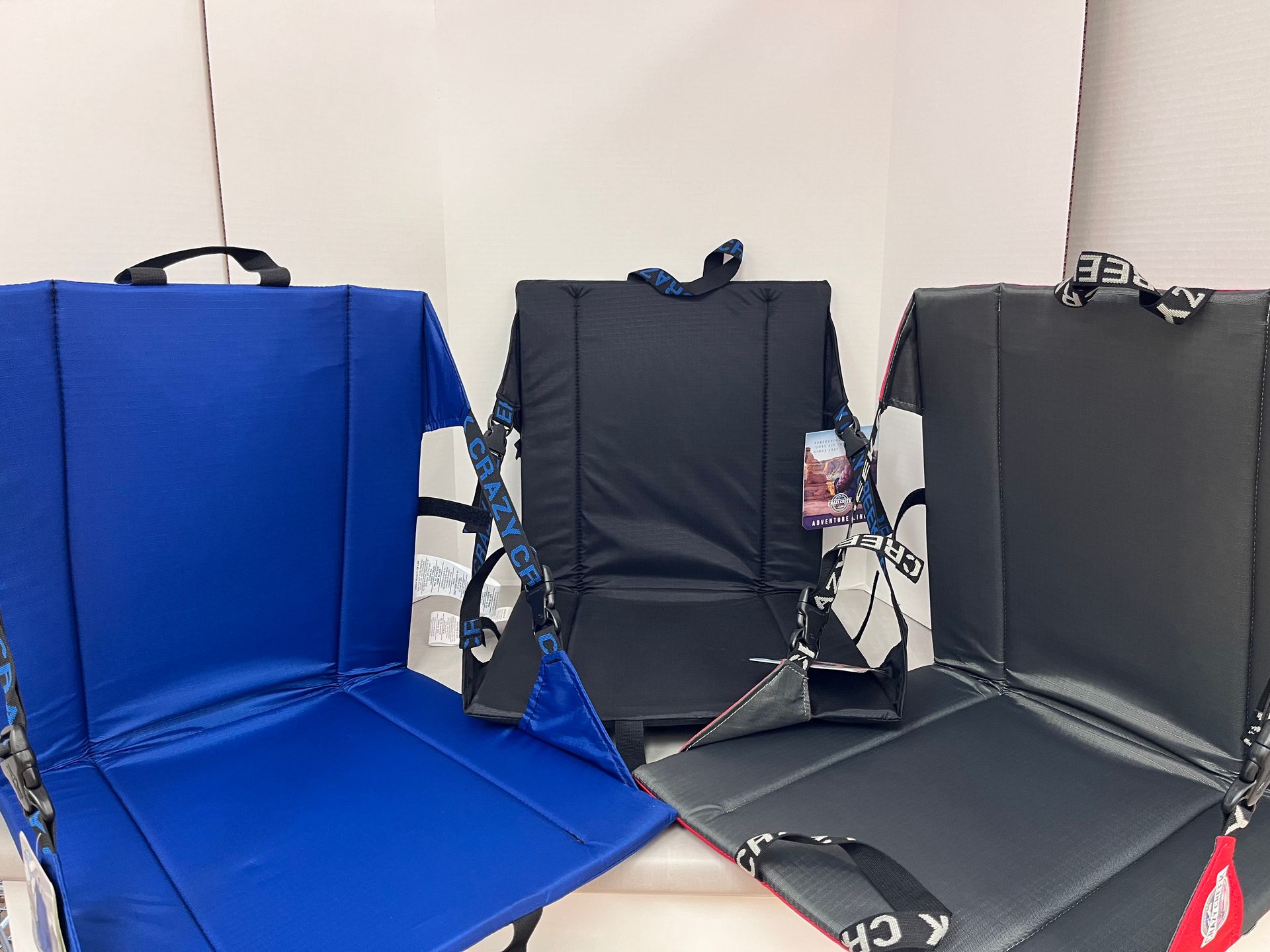 three folding chairs are sitting next to each other on a table .