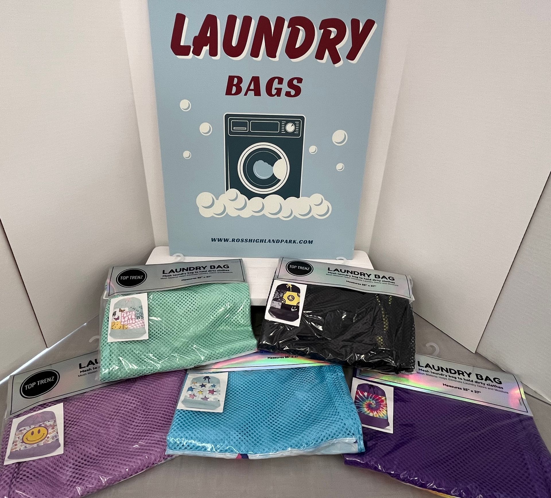 a bunch of laundry bags are sitting under a sign that says laundry bags