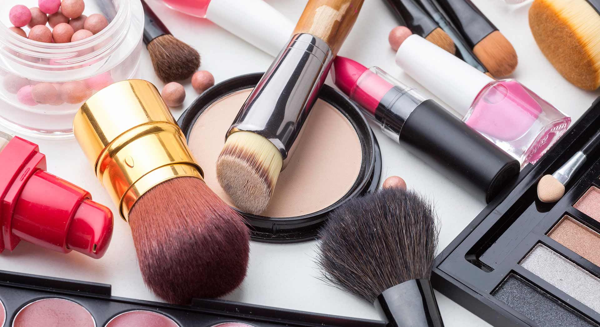 a white background with makeup and perfume on it .