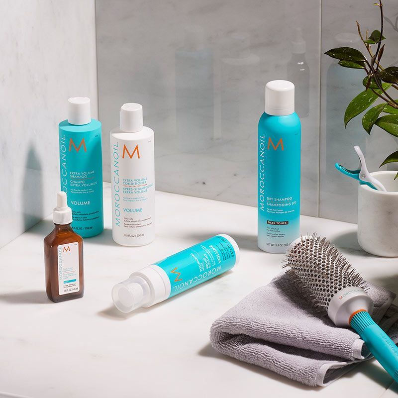 bottles of moroccanoil hair products are sitting on a counter