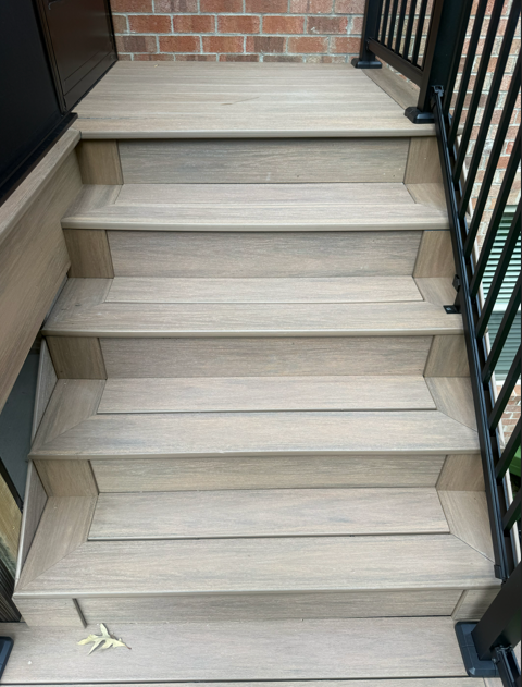 Professional carpenter uses metal hammer for deck board repair.