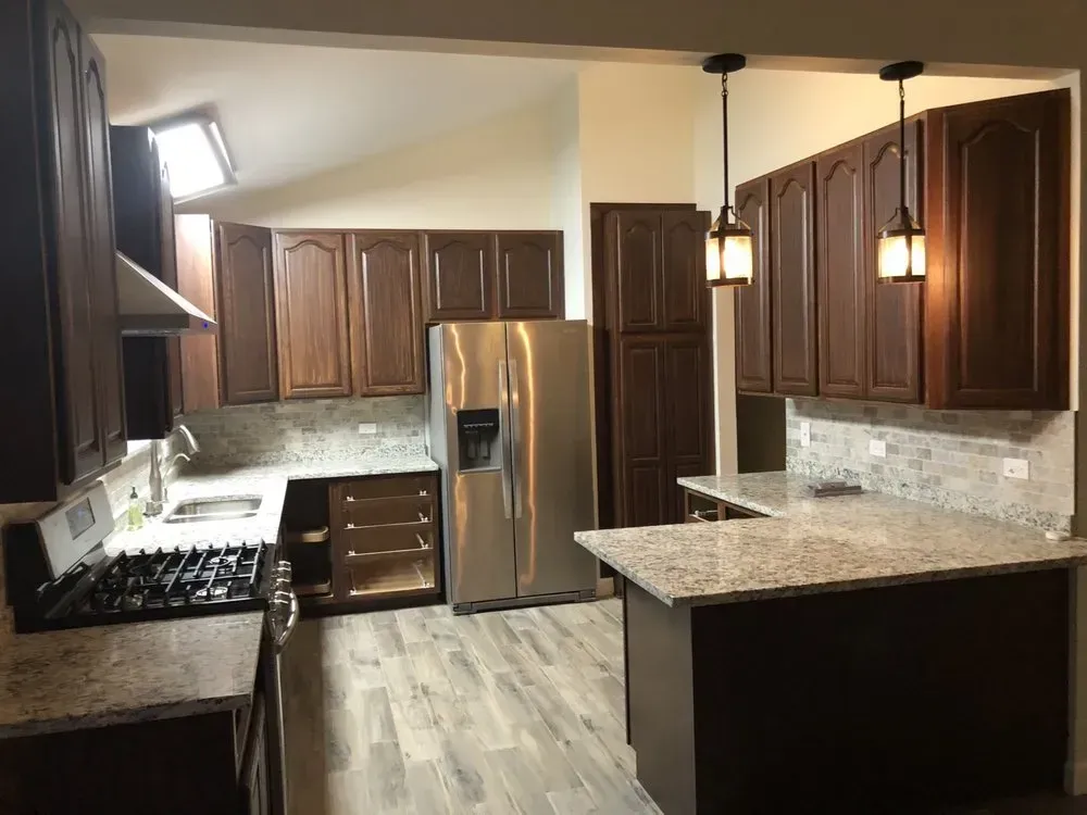A kitchen with stainless steel appliances and wooden cabinets