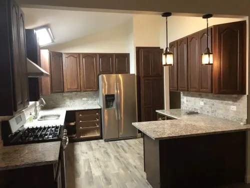 A kitchen with stainless steel appliances and wooden cabinets