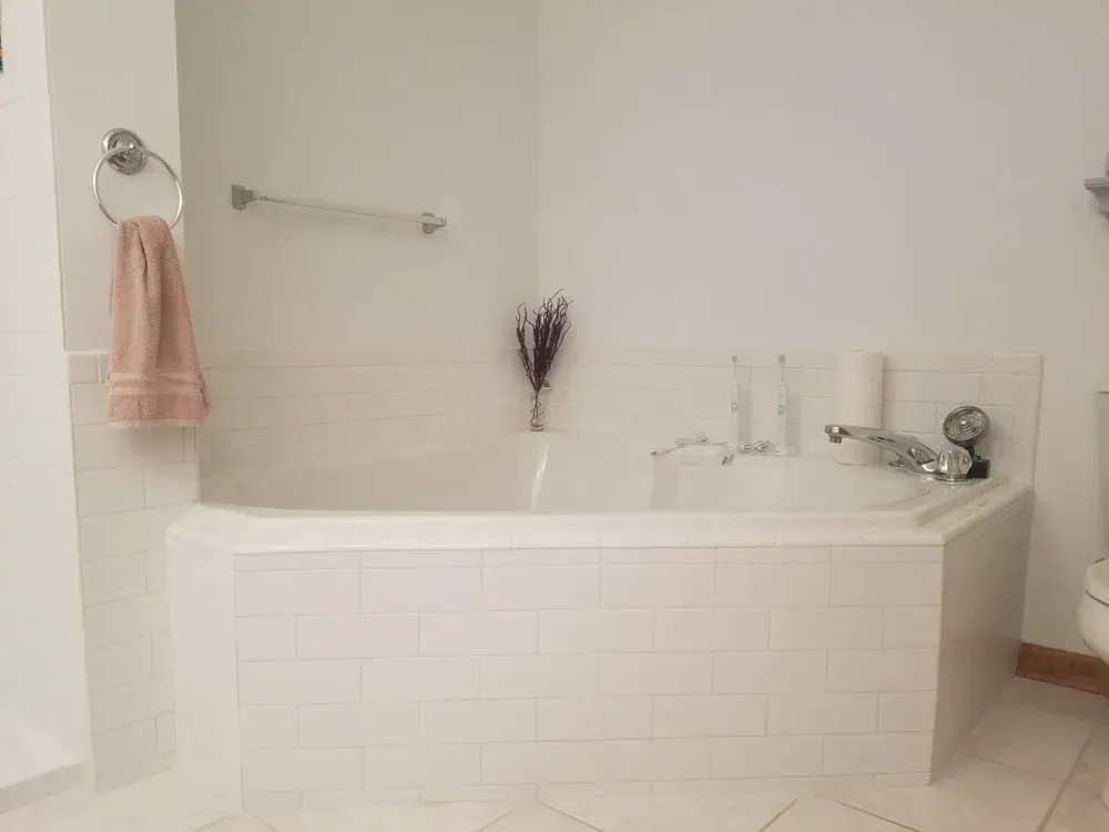 A bathroom with a bathtub and a toilet.
