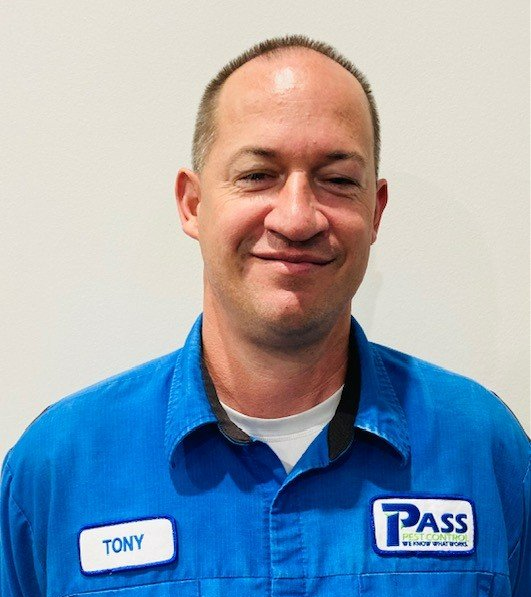 Man wearing a blue uniform with a name tag that reads