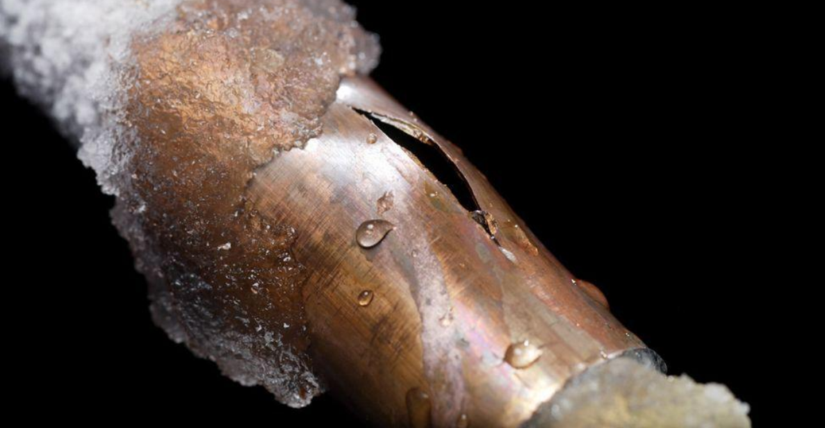 Frozen pipe sticking out from building