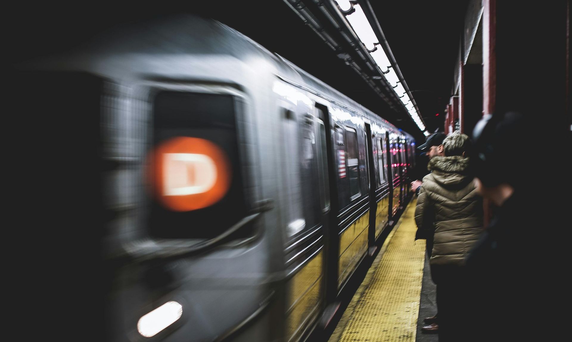 New York City Subway D Train arriving into a station