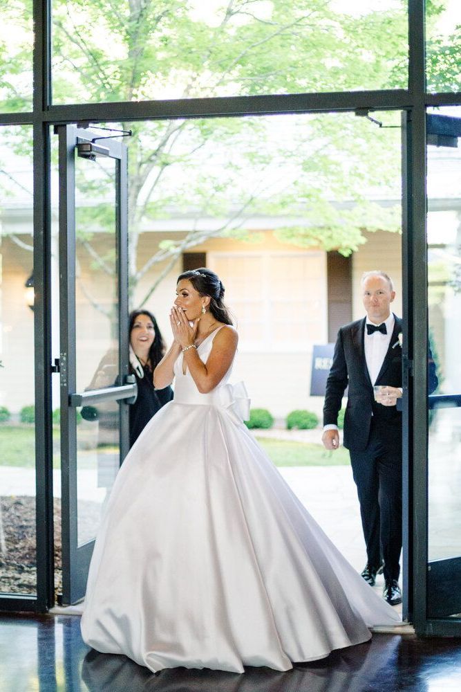 Bride in a Wedding Dress Is Walking Down the Aisle with Her Groom by Wedding Planner Nashville