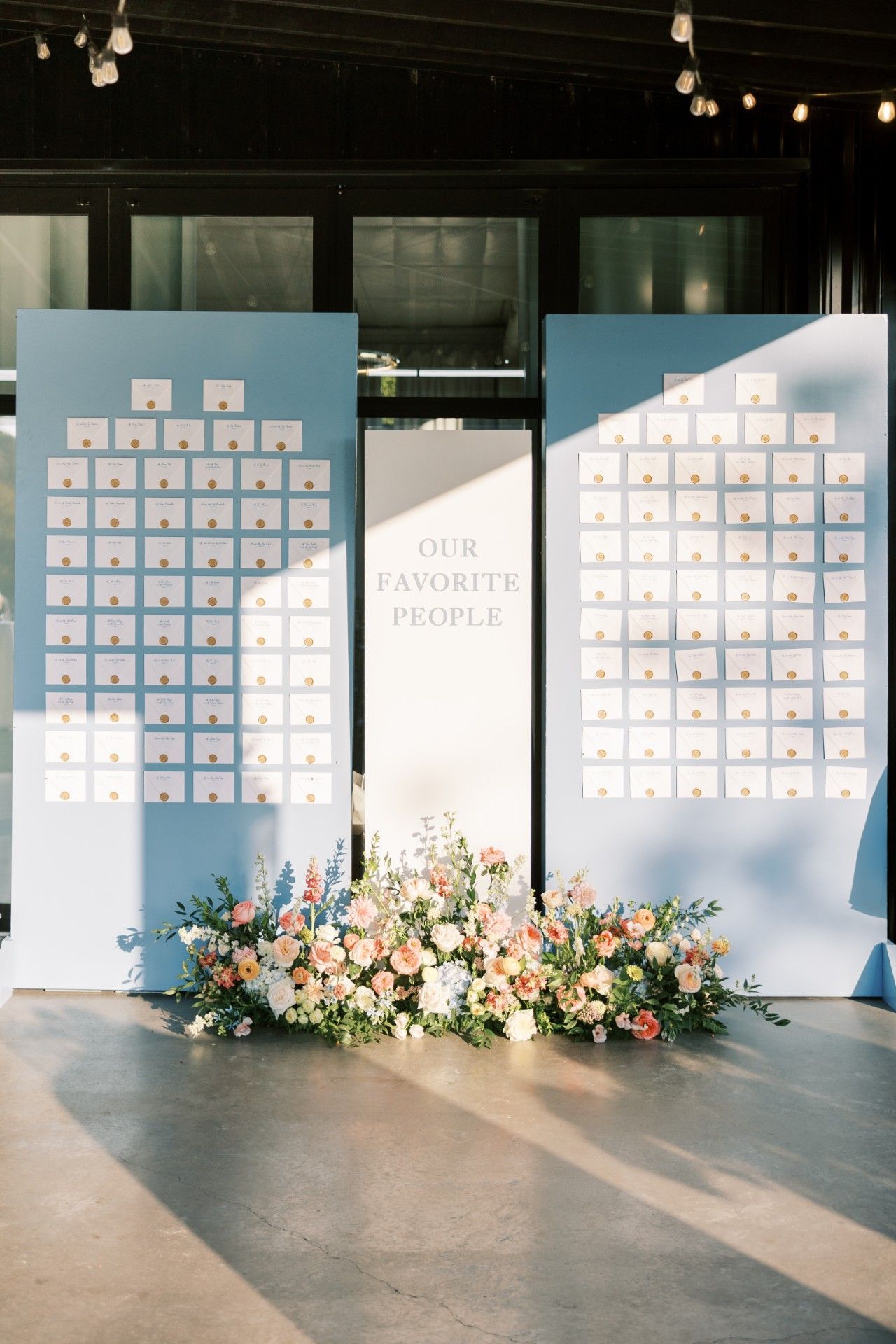 A wedding seating chart with flowers in front of it by Luxury Wedding Planners in Nashville, TN