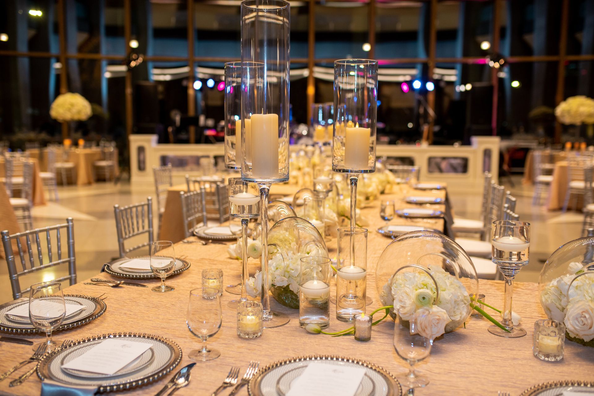 Danielle and Matt’s Wedding table set for a wedding reception with plates, silverware, candles and flowers by Wedding Planner Nashville