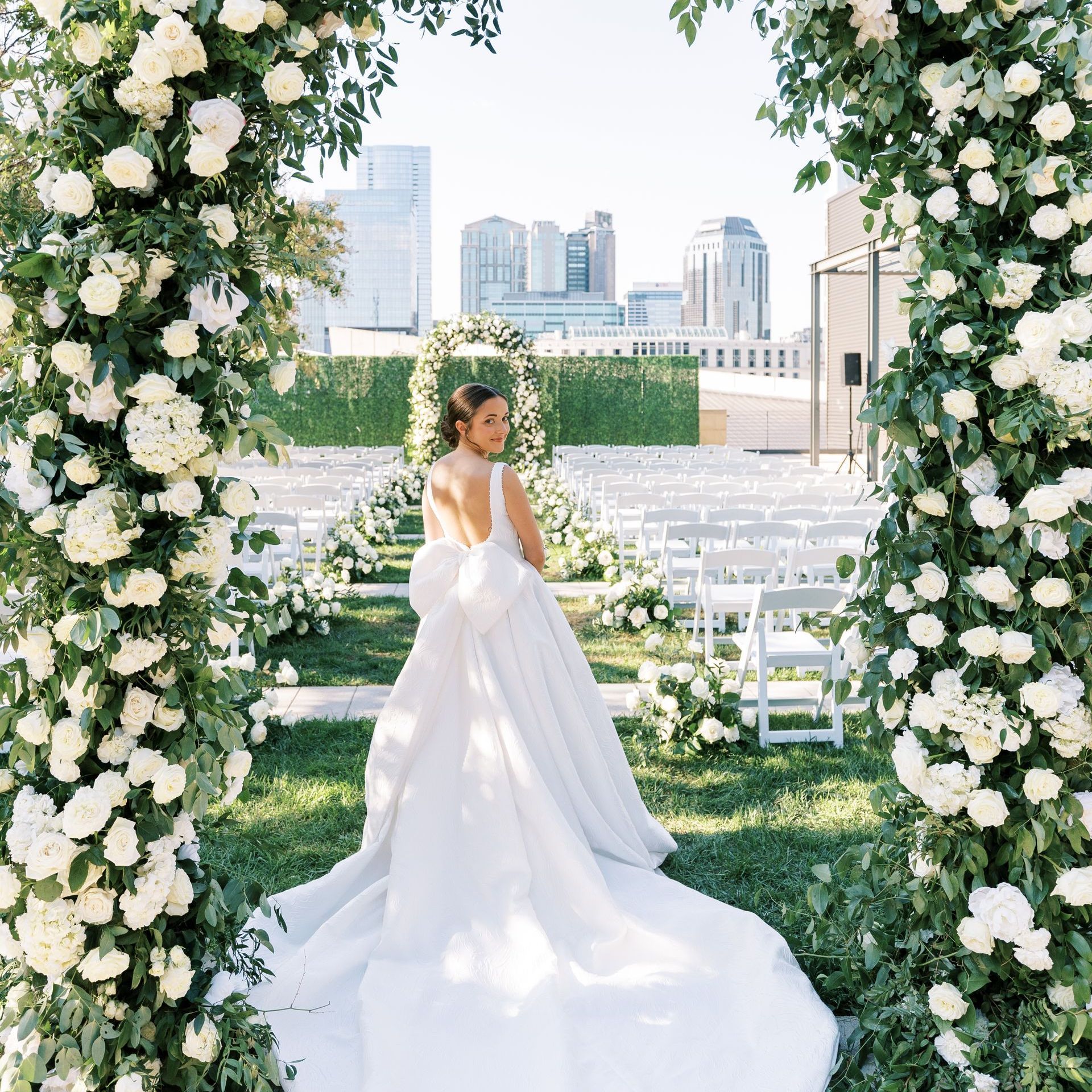 A Bride in a Wedding Dress Is Walking Down the Aisle with Her Groom by Wedding Planner Nashville