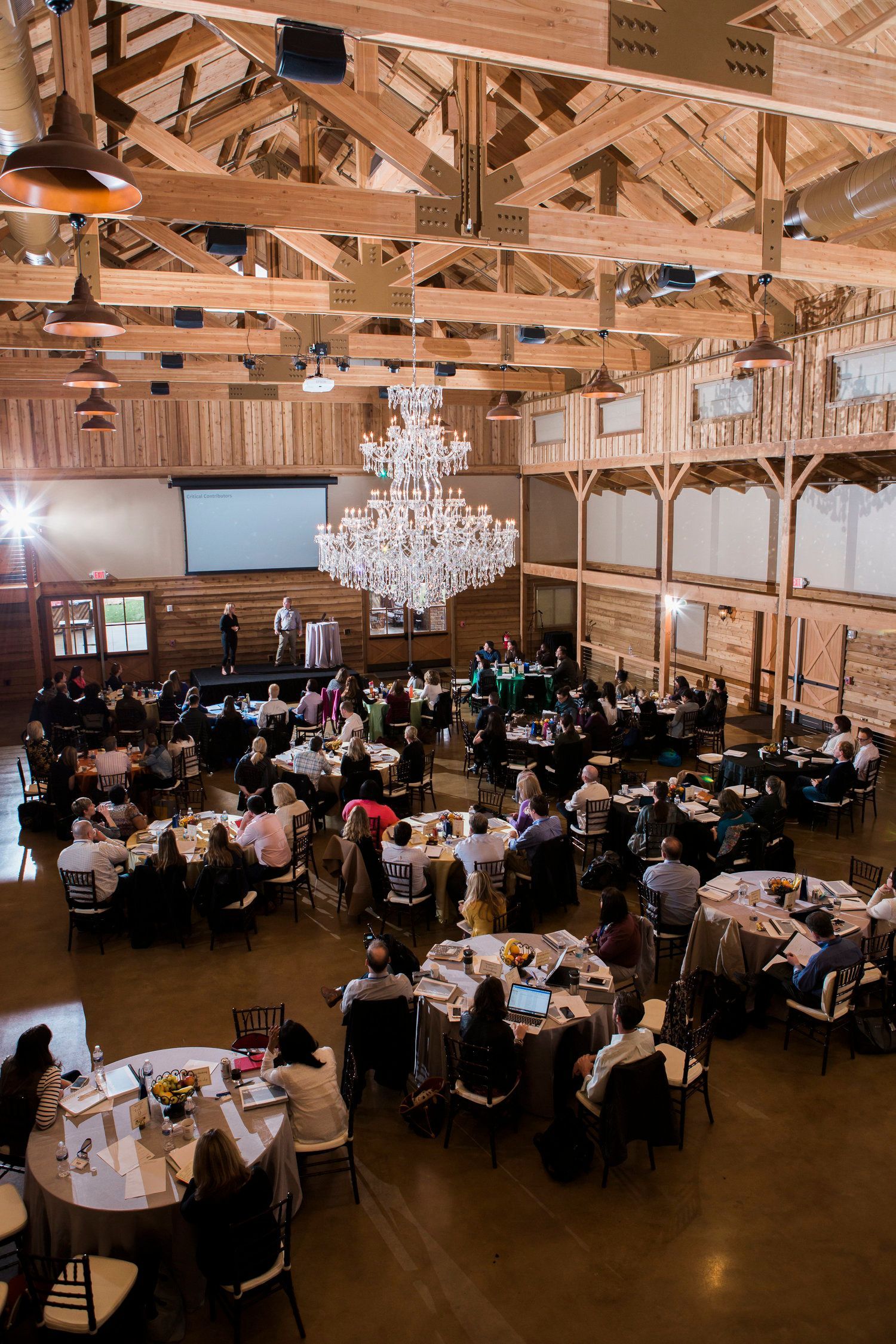 MARS Petcare Event room filled with tables and chairs and a chandelier by Wedding Planner Nashville