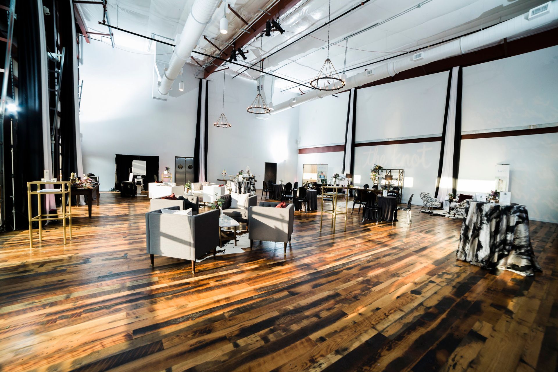 Large room for a corporate event with wooden floors and chairs in it by Event Planner Nashville