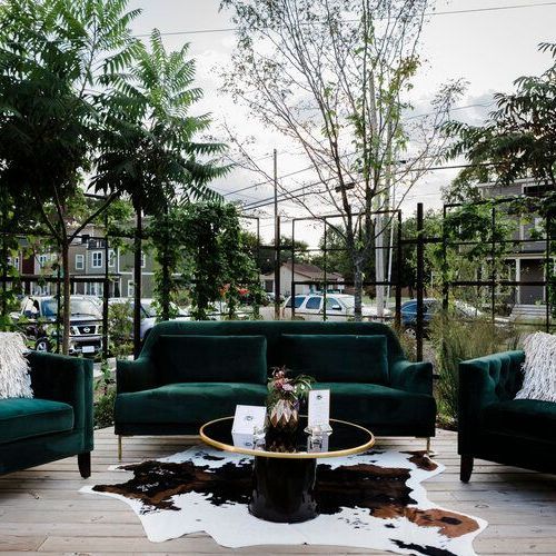 Couch and two chairs are sitting on a wooden deck by Wedding Planner Nashville