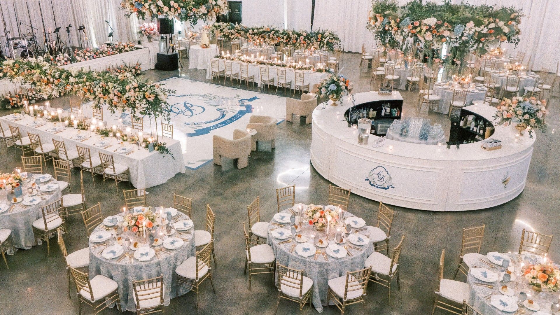 A large room filled with tables and chairs and a bar by Luxury Wedding Planners in Nashville, TN