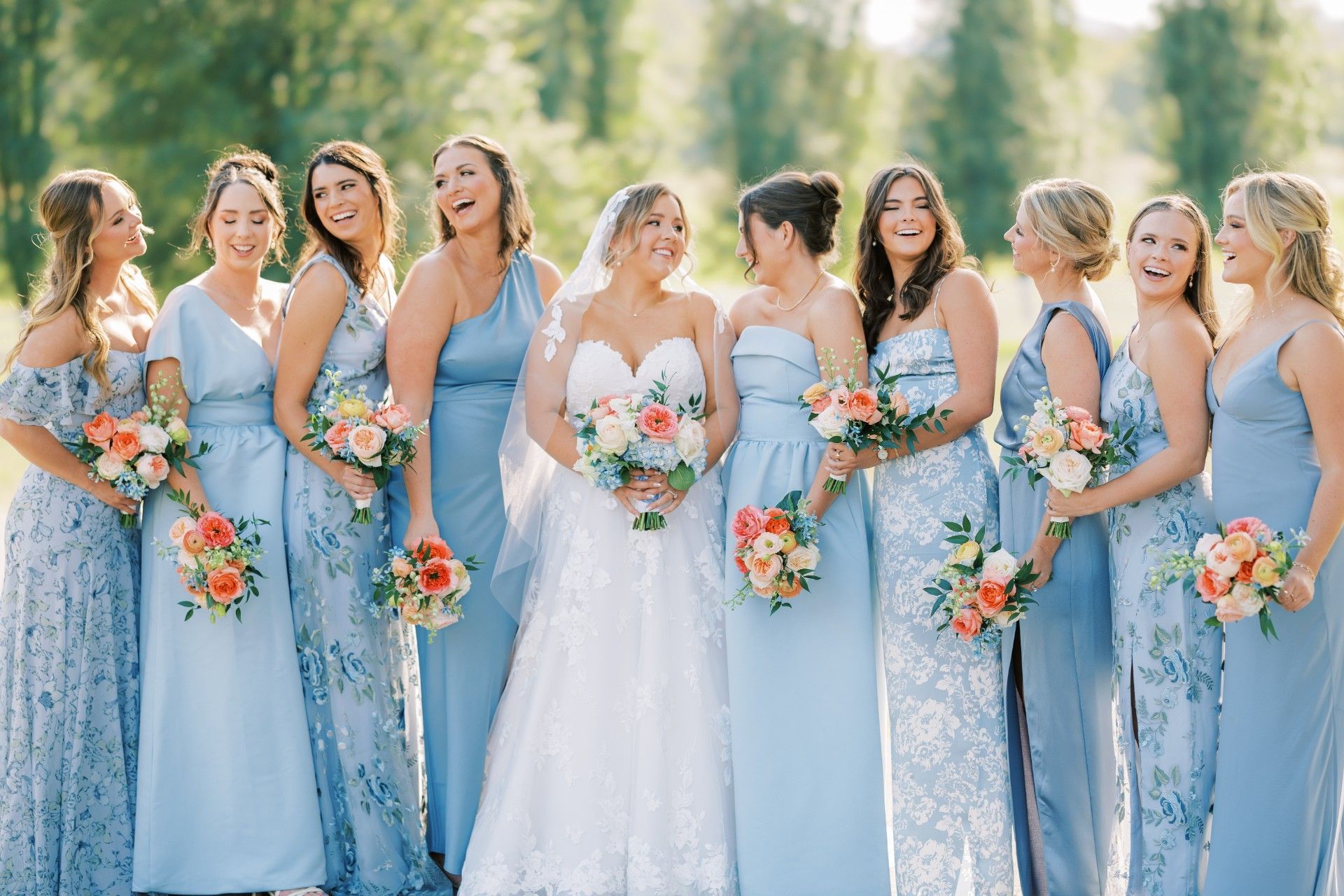A bride and her bridesmaids are posing for a picture together by Luxury Wedding Planners in Nashville, TN