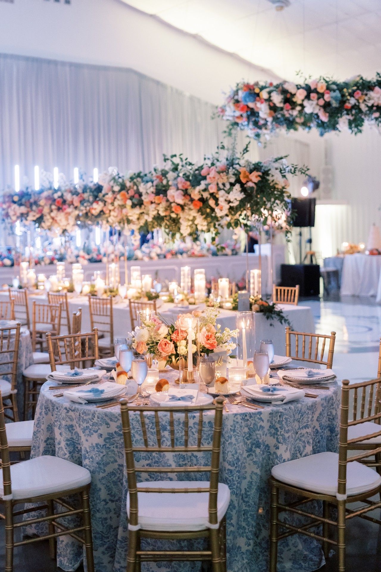 A large room with tables and chairs set up for a wedding reception by Luxury Wedding Planners in Nashville, TN